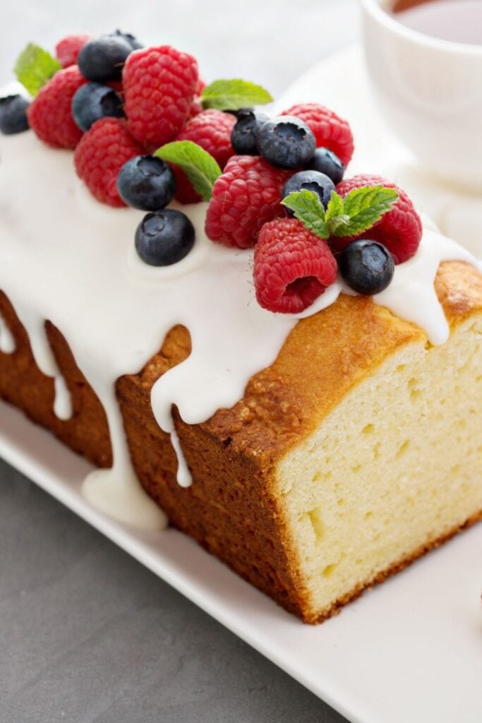 17 Easy Yogurt Cake Recipes (Moist & Fluffy): Yogurt Pound Cake with Vanilla Glaze and Berries