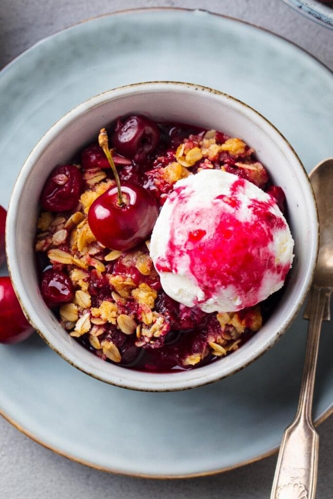 Homemade Cherry Crisp with Ice Cream in a Bowl