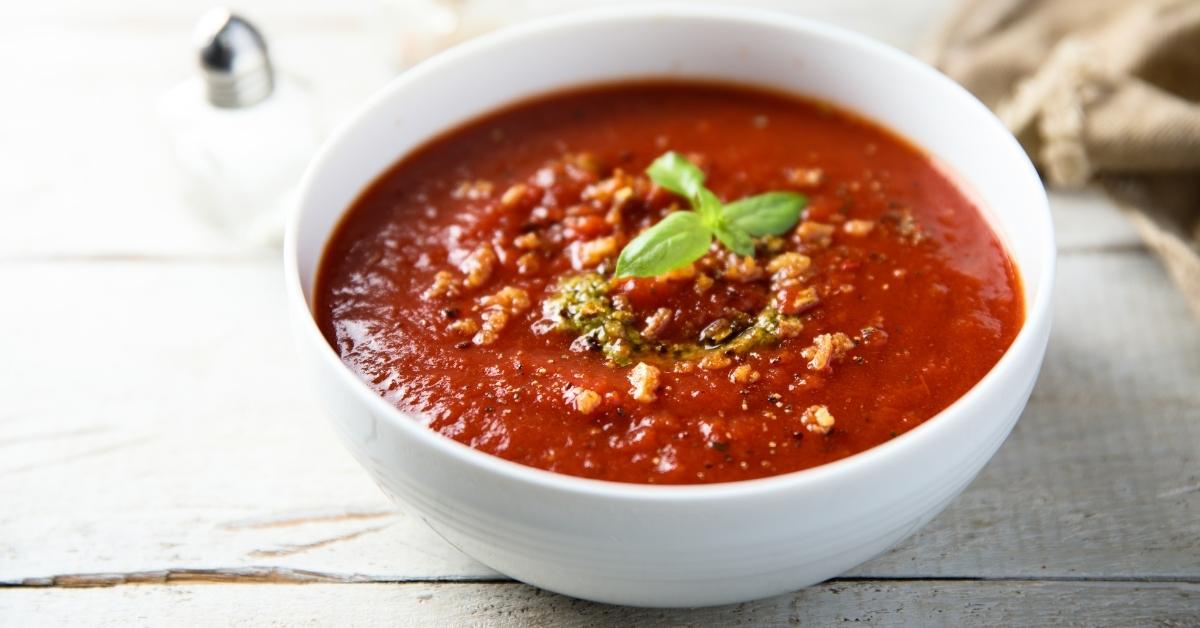 Homemade Tomato Soup with Pesto Sauce in a White Bowl