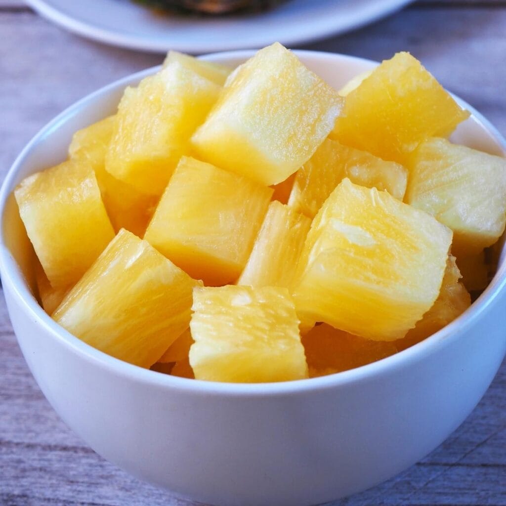 Fresh Pineapple Chunks in a White Bowl
