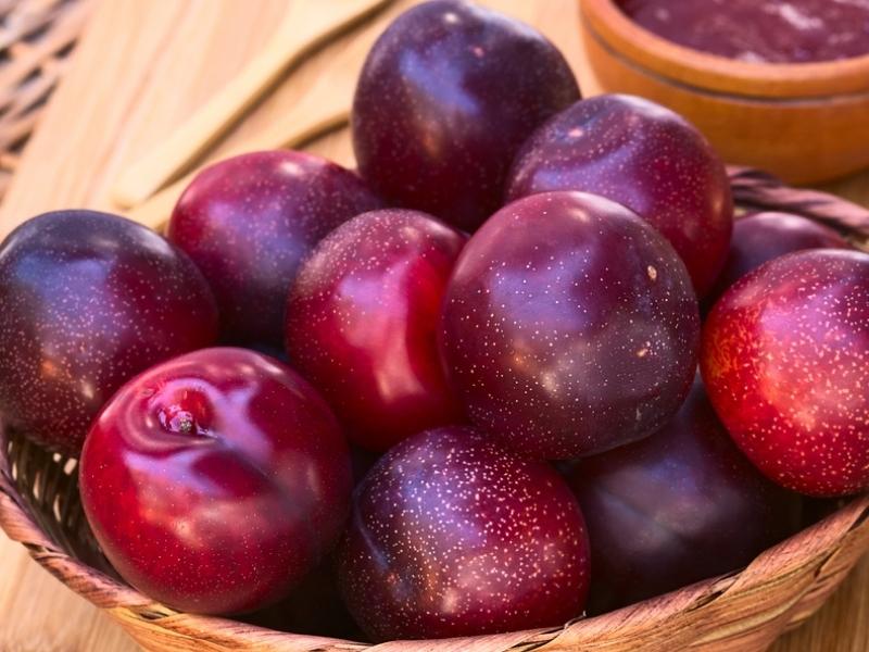 Bunch of Blood Plum on a Woven Basket