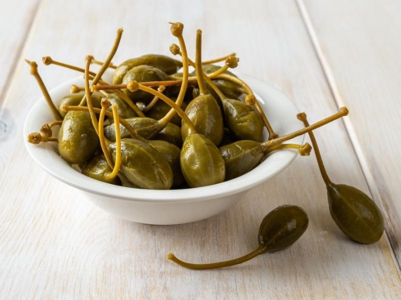 Caperberries on a Small White Bowl
 