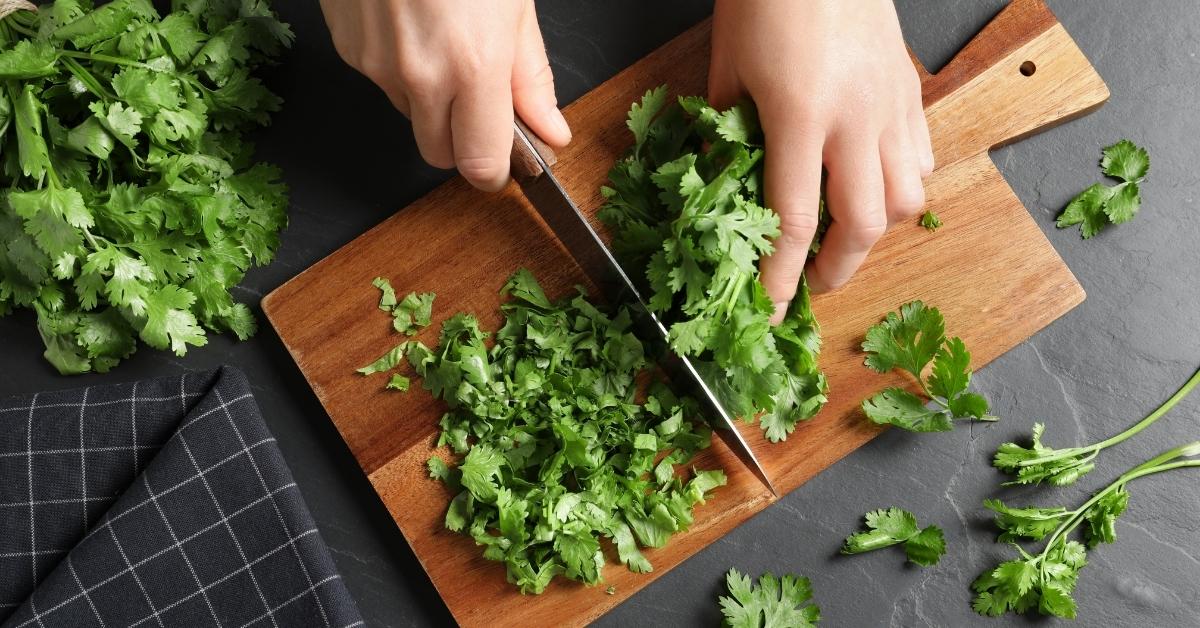 Chopping Cilantro in a Wooden Cutting Board