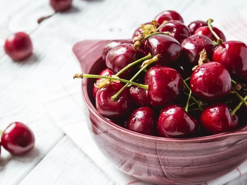 Coral Champagne Cherries on a Wooden Bowl