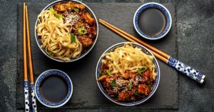 Homemade Teriyaki Chicken Noodle Bowl with Soy Sauce and Chopsticks