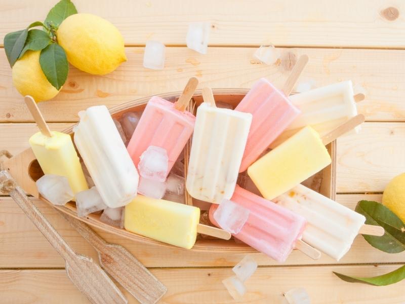 Ice Popsicles on a Wooden Boat Shaped  Tray Filled With Ice