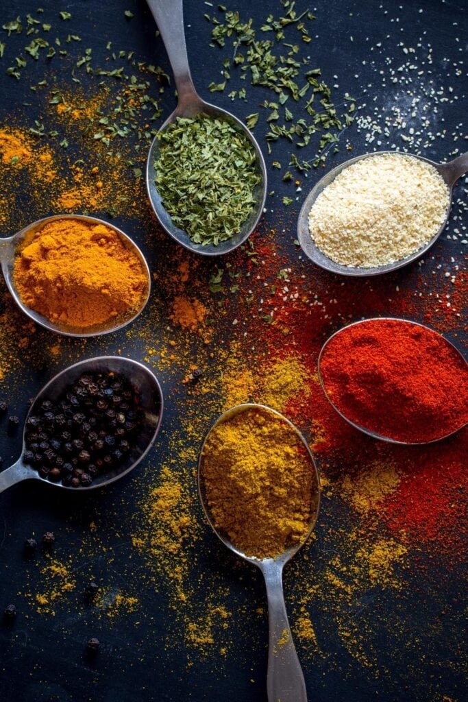 Organic Herbs and Spices in Teaspoons: Salt, Paprika, Ground Ginger, Black Pepper and Thyme