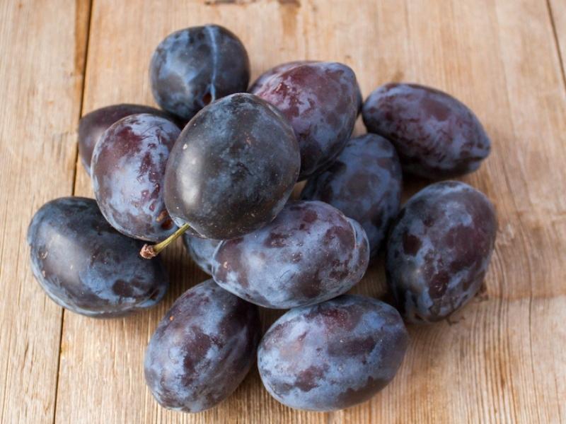 Simka Plums on a Wooden Table