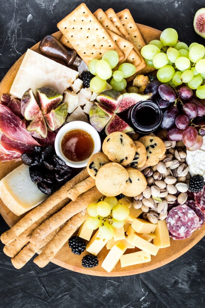 Appetizing Charcuterie Board: Parmesan, Cheddar, Gouda, Salami, Fruits and Nuts