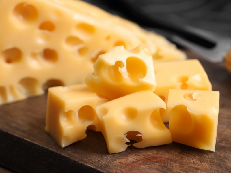 Sliced Emmental Cheese on a Wooden Chopping Board
