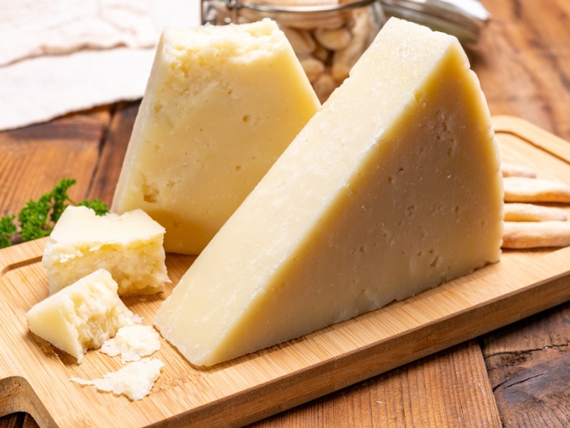 Pecorino Romano Slices on a Wooden Chopping Board