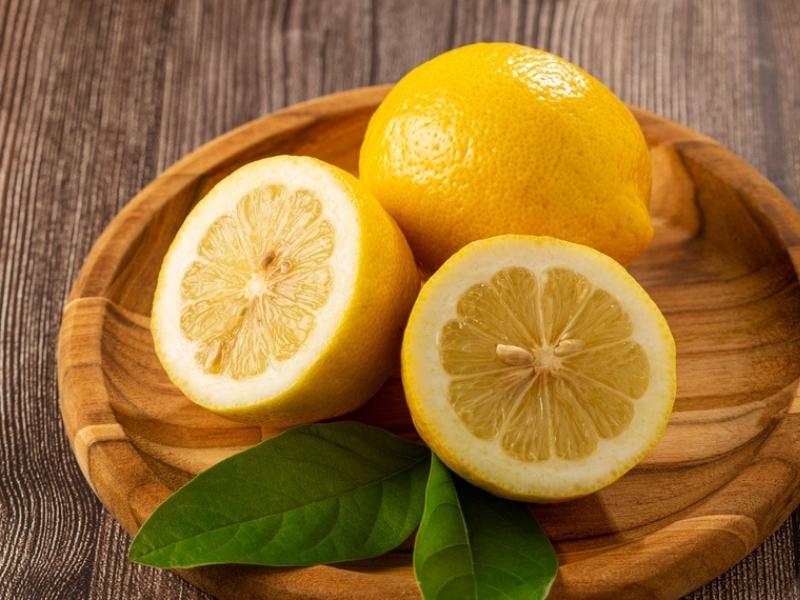 Fresh Ripe Santa Teresa Lemons on a Wooden Plate