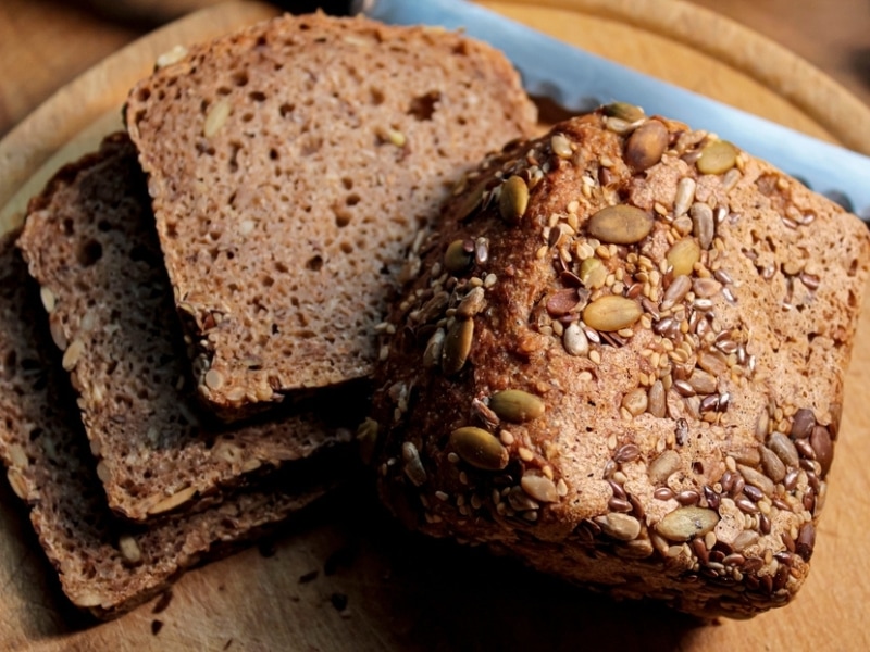 Seeded Bread in a Round Wooden Cutting Board