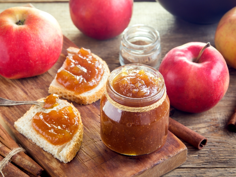 A Jar of Apple Butter with Cinnamon and Bread