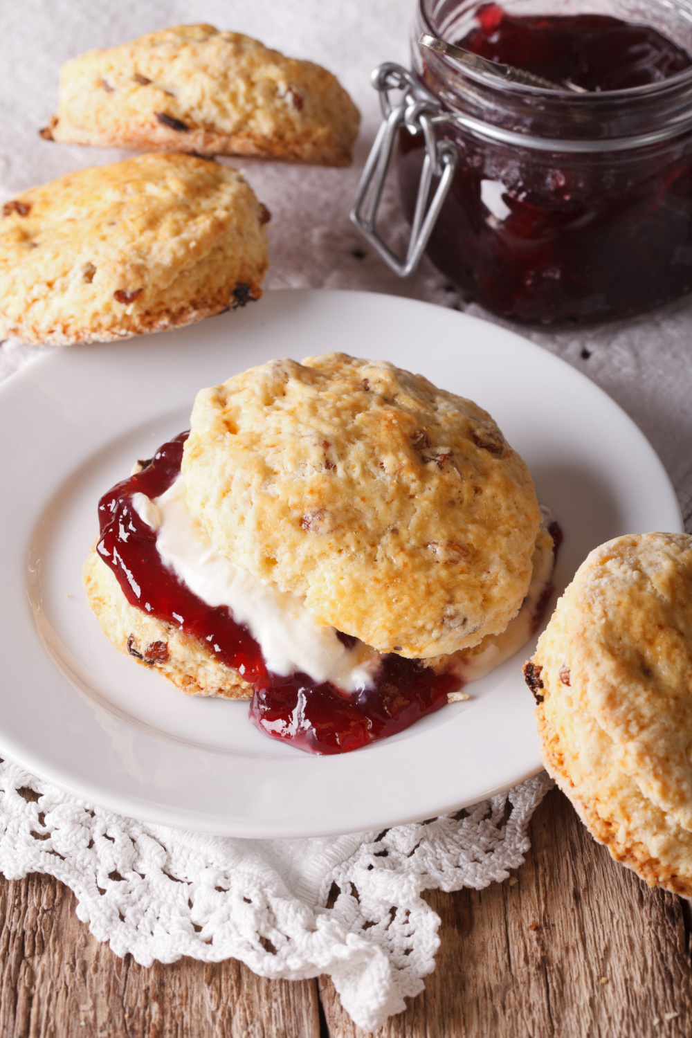 Buttermilk scones with red currant jam served on saucer