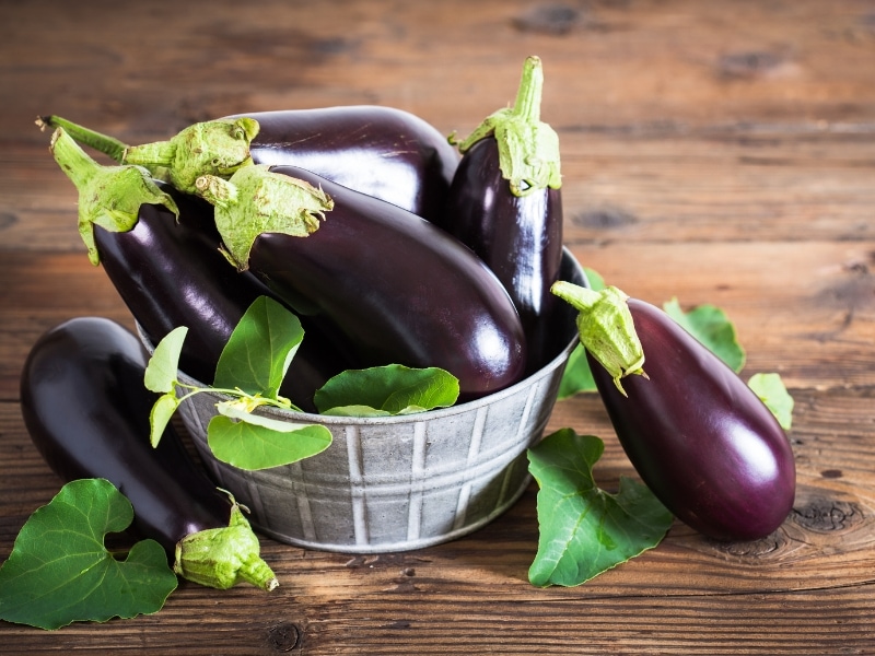 Fresh Eggplants on Table