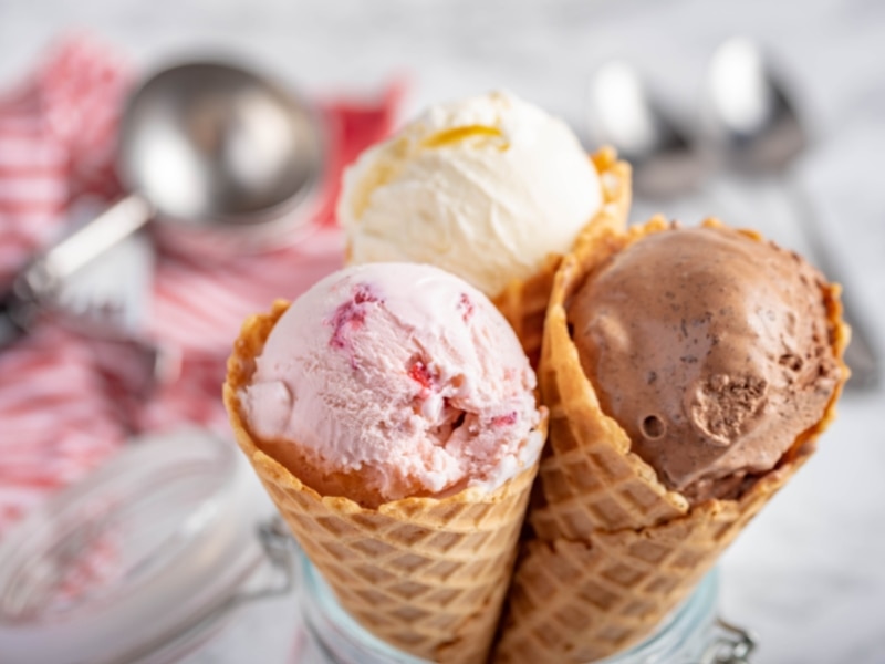 Three waffle cones with vanilla, chocolate, and strawberry ice cream