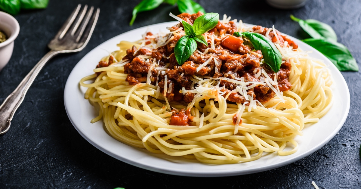 Homemade Pasta Bolognese with Ground Beef and Tomato Paste in a White Plate