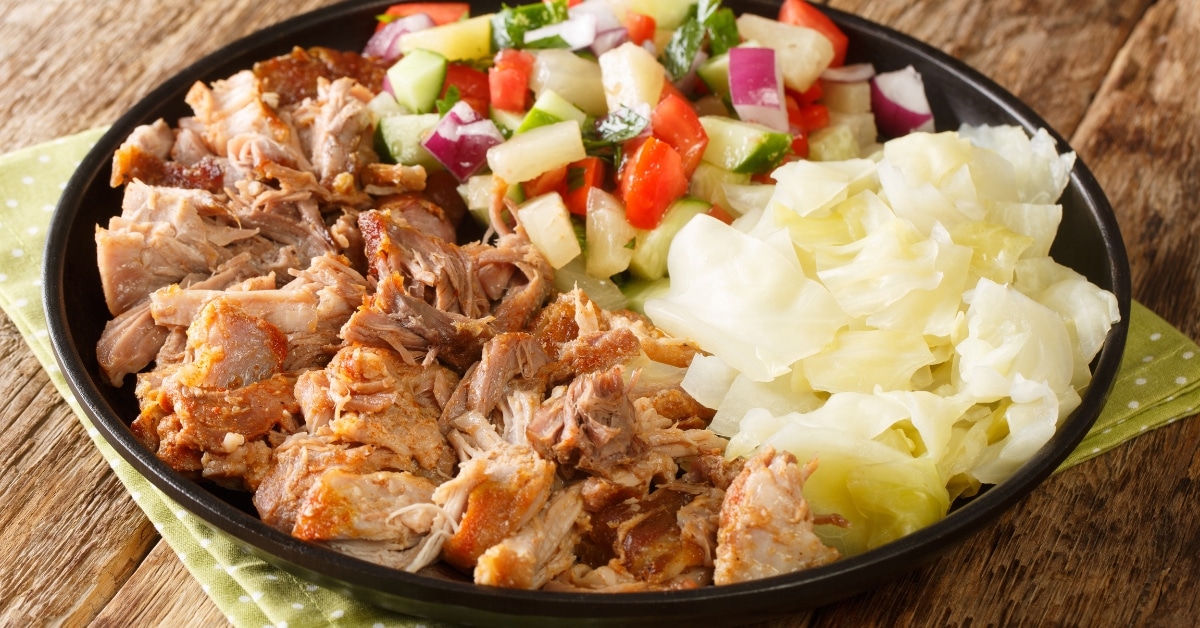 Homemade Slow Cooked Pulled Pork with Cabbage and Pineapple Salad in a Black Plate