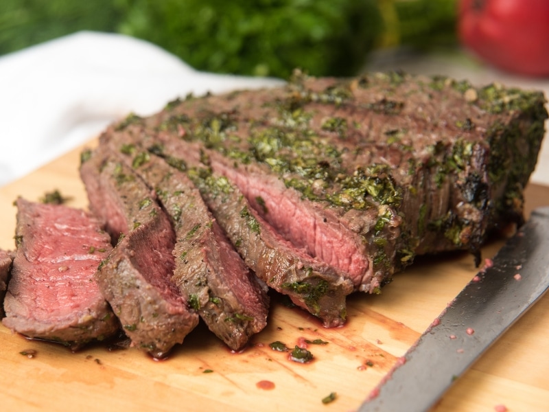 London Broil Steak Sliced on a Wooden Cutting Board