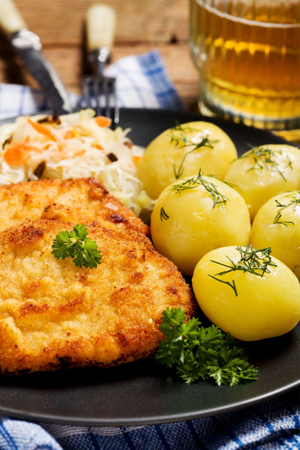 Oven fried porkchops served with baked peeled potatoes and coleslaw. 