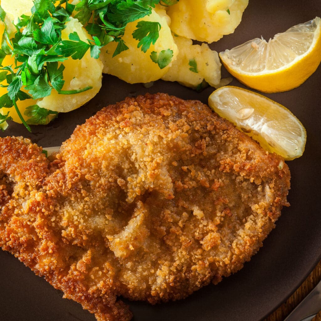 Oven-Fried Pork Chops Served on Black Plate 