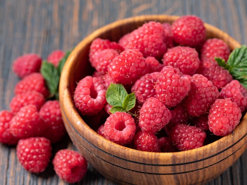 Wooden Bowl Full of Raspberries