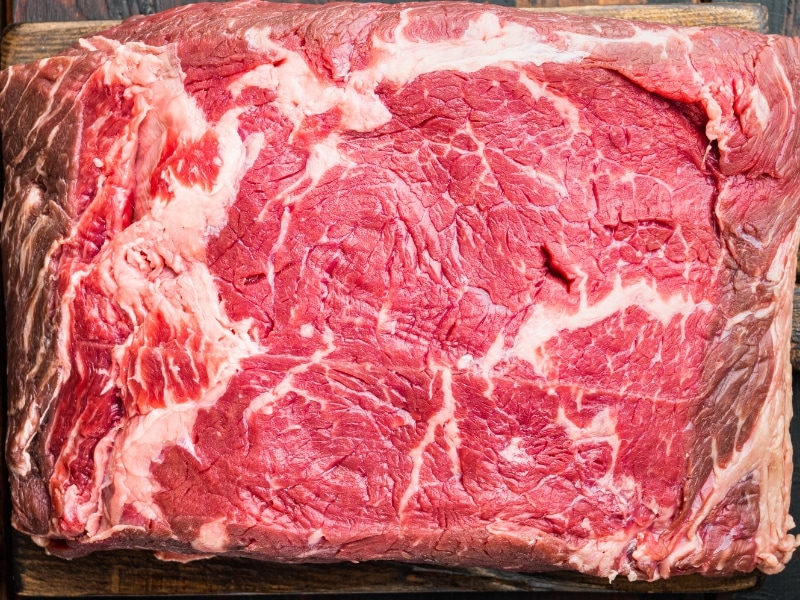 Raw Sirloin Steak in a Wooden Cutting Board