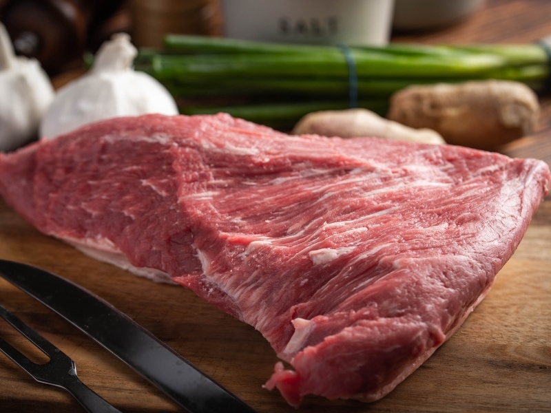 Raw Tri Tip Steak in a Wooden Cutting Board