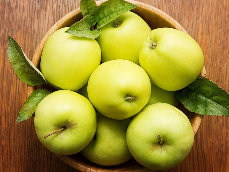 Crispin Apple on a Round Wooden Bowl and Table 