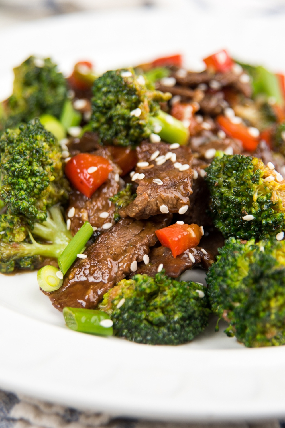 Broccoli and Rice with Oyster Sauce and Sesame Seeds Served on a White Plate