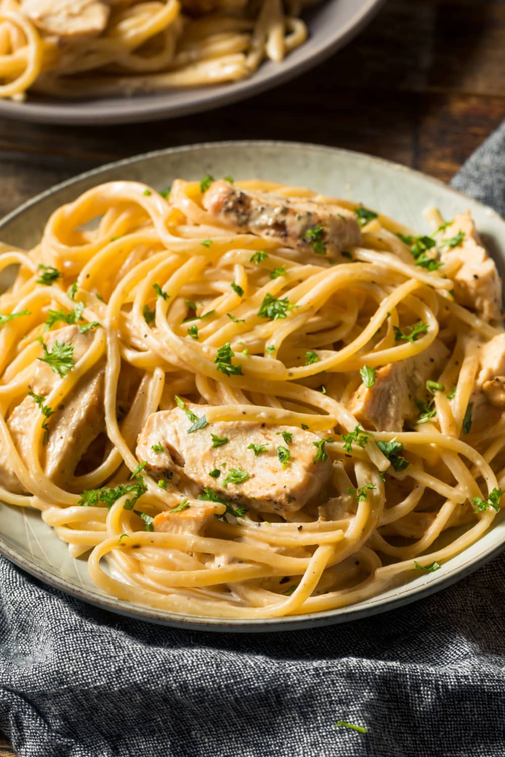 Homemade Chicken Alfredo with Herbs in a Plate