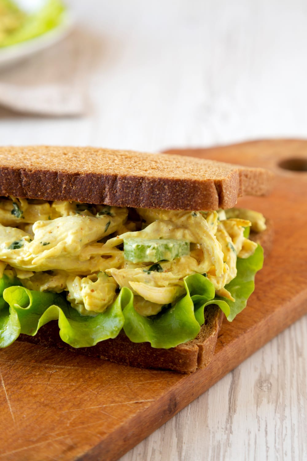 Coronation Chicken Sandwich on wooden board