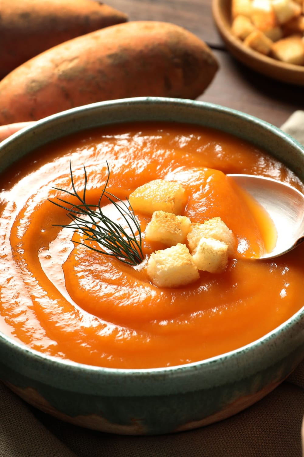 Sweet Potato Soup on a bowl garnish with croutons.