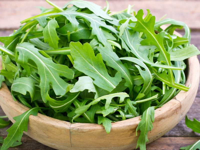 Fresh Arugula in a Wooden Bowl