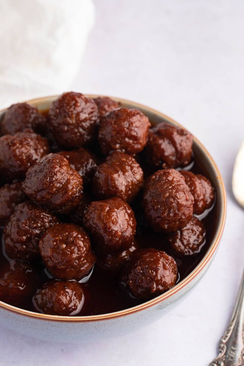 Bowl of meatballs with grape jelly sauce. 