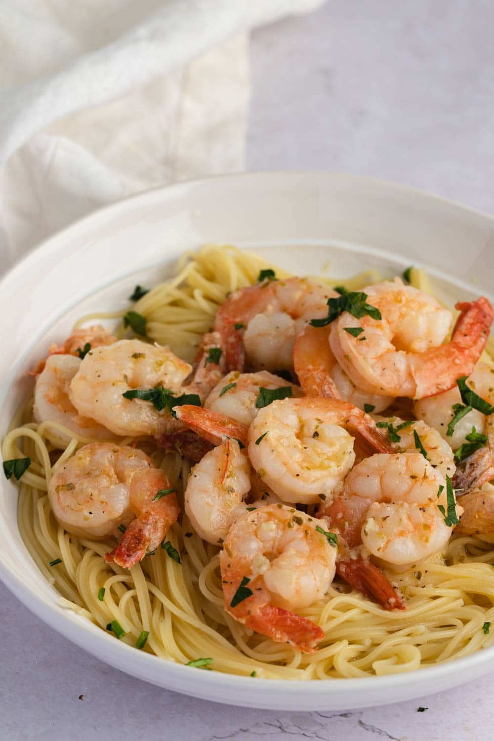 Buttery and Tender Red Lobster Shrimp Scampi with Pasta Served on a White Plate, Garnished with Chopped Parsley