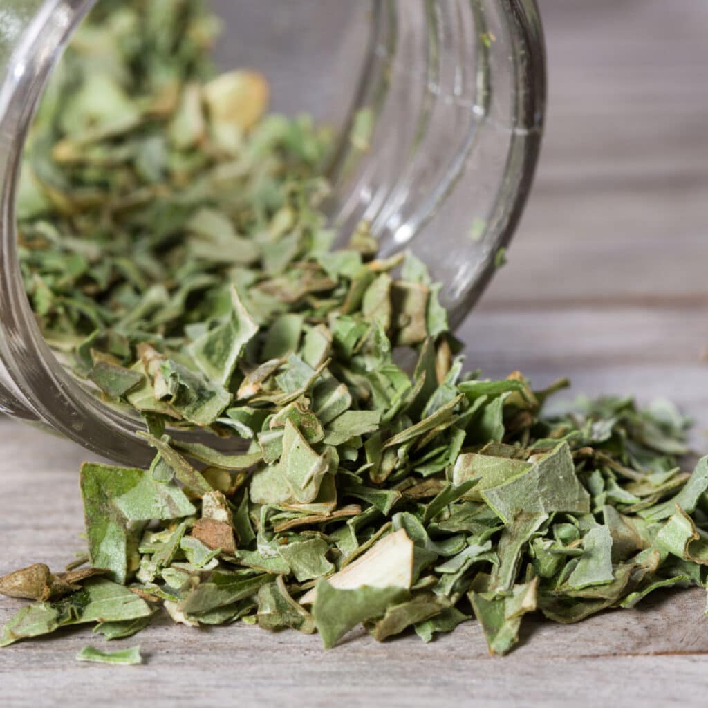 Dried Basil Poured on Glass