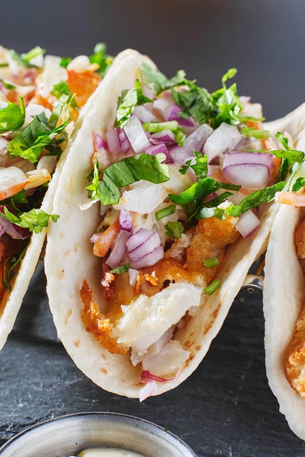 Mexican Fish Taco with Sliced Red Onions and Chopped Parsley