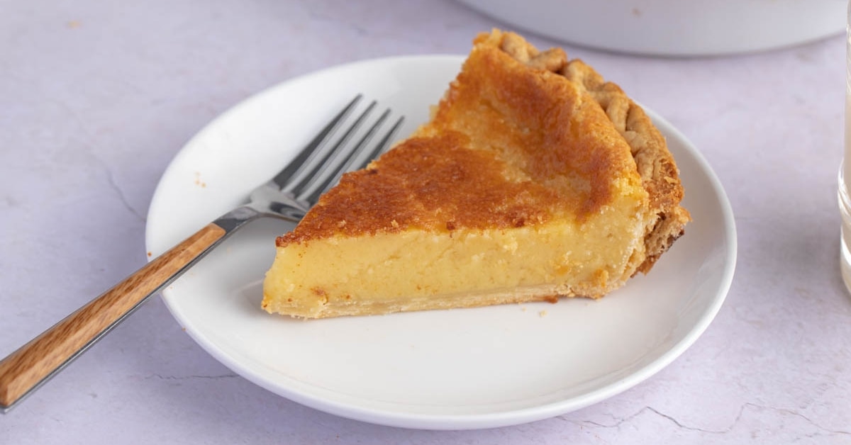 Sliced Homemade Silky Eggnog Pie in a White Plate