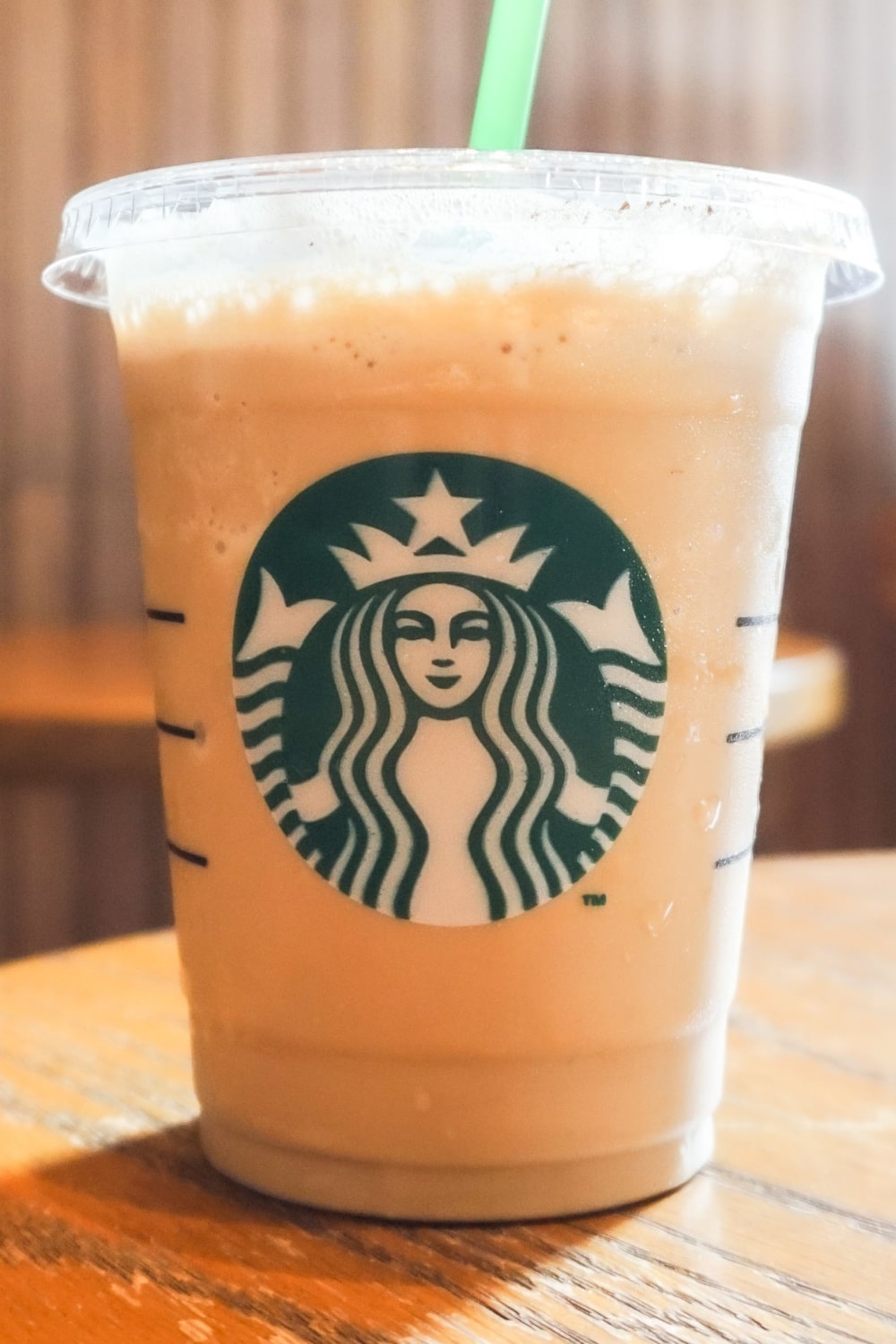 Starbucks Iced Blonde Vanilla Latte on a Wooden Table