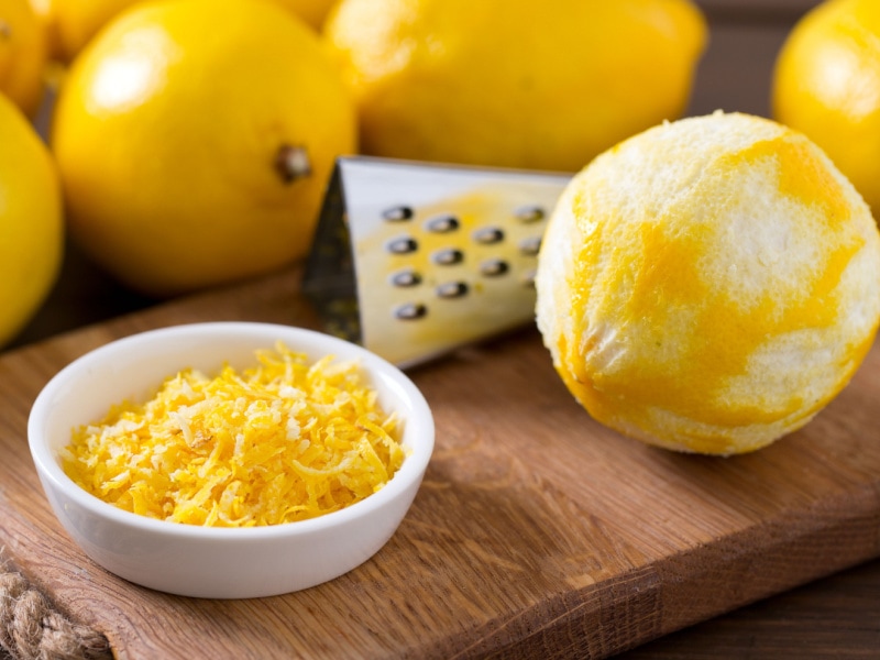 Ripe Lemons  and Lemon Zest on a Small White Condiments Dish