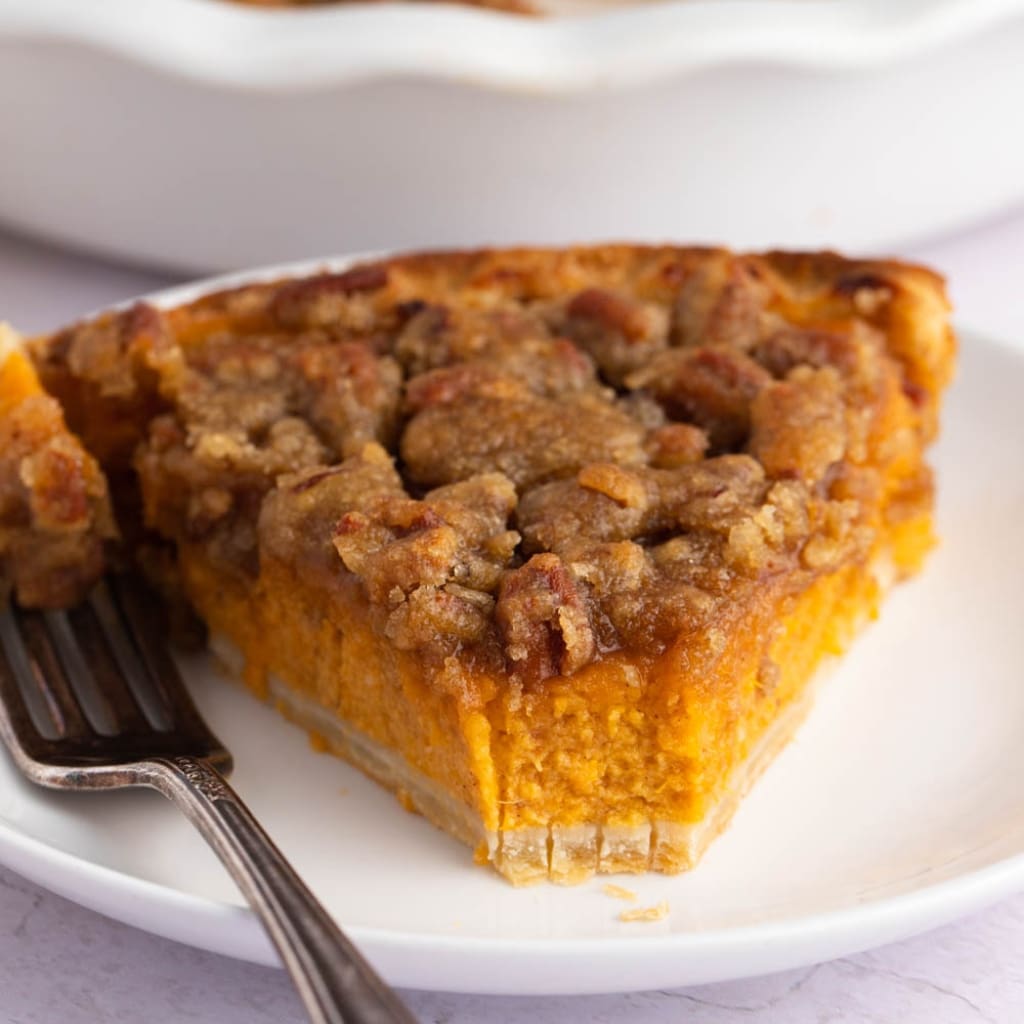 Sliced Sweet Potato Pecan Pie in a White Plate