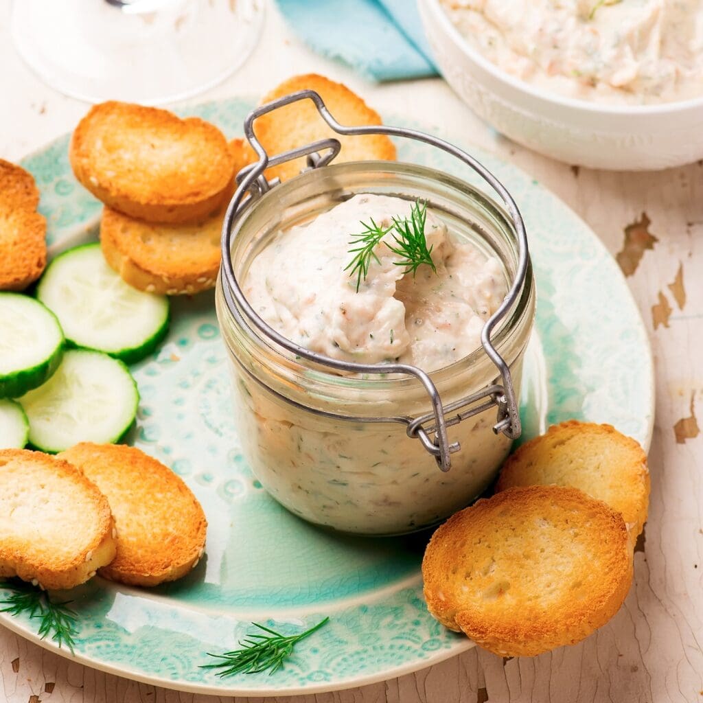 Smoked Salmon Dip in a Glass Jar with Biscuits and Sliced Cucumbers