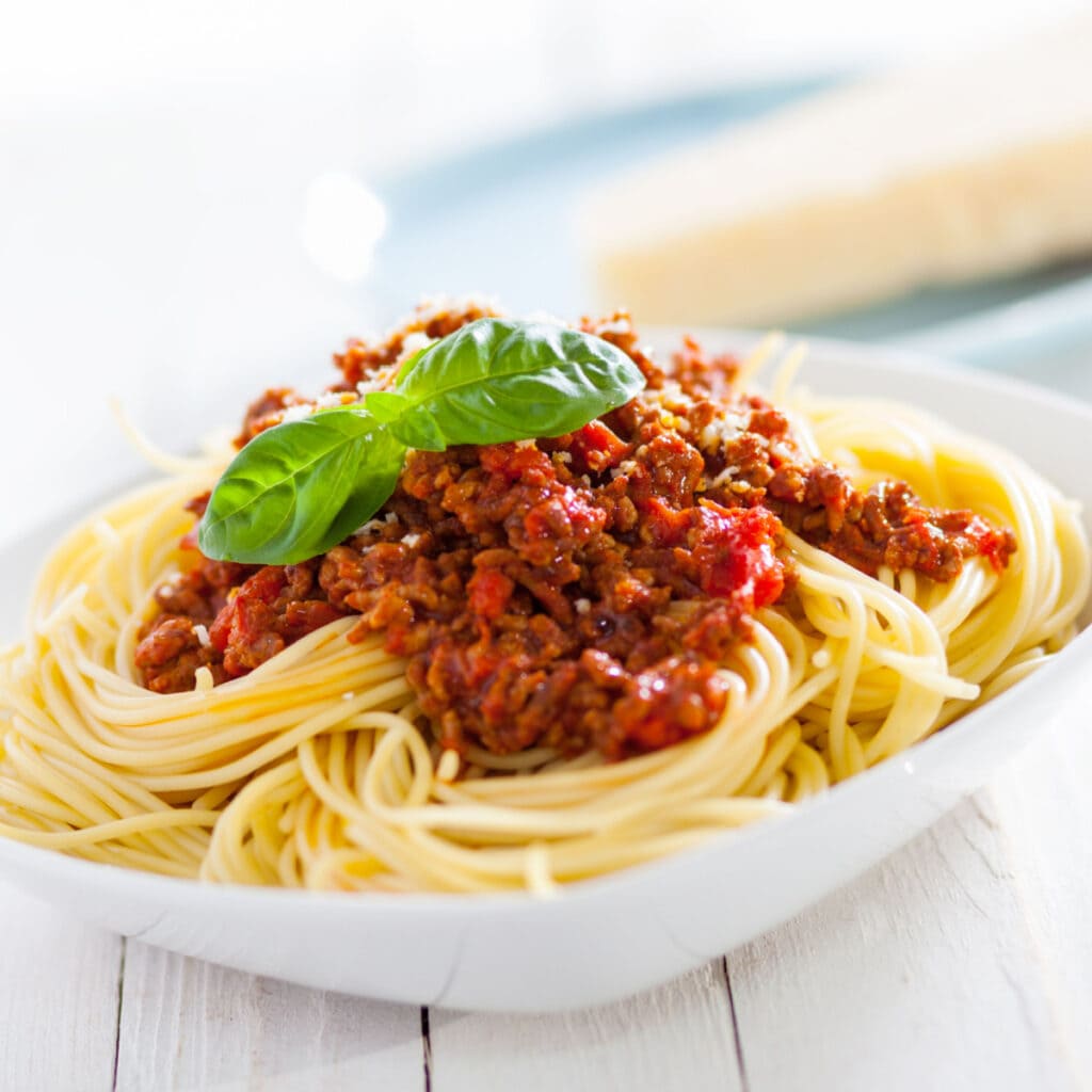 Spaghetti Topped With Meaty Sauce and a Fresh Mint Leaves