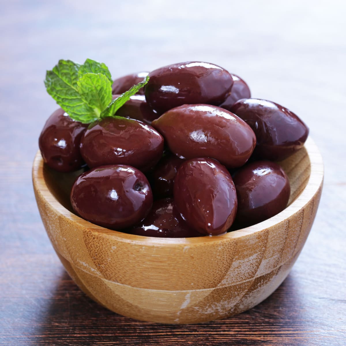 Fresh Kalamata Olives on a Small Wooden Bowl