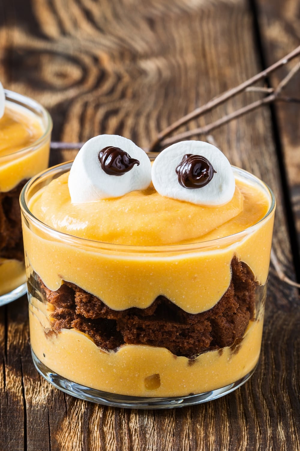 Layered No-Bake Chocolate Trifle with Mascarpone Cream on a Glass on Top of a Dark Brown Wooden Table