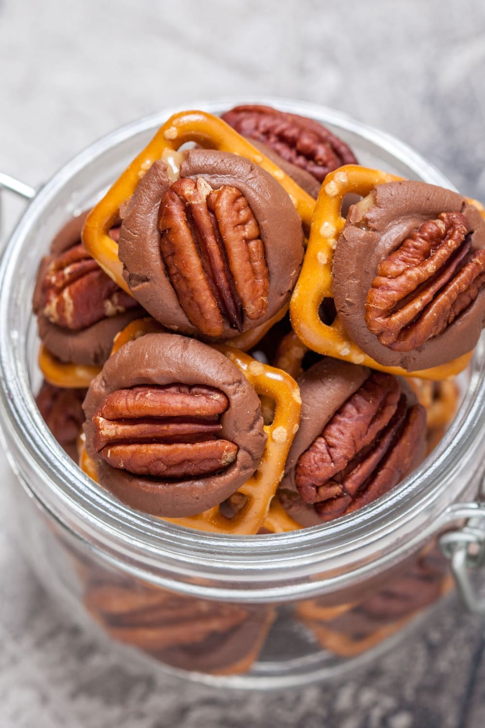A jar full of Rolo candies made with pretzels, chocolates and pecan nuts. 