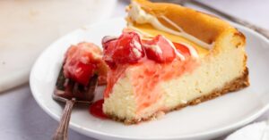 Sliced Homemade Strawberry Chocolate Cheesecake with Strawberry Sauce