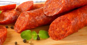 Sliced Pepperoni Sausages on a Wooden Cutting Board